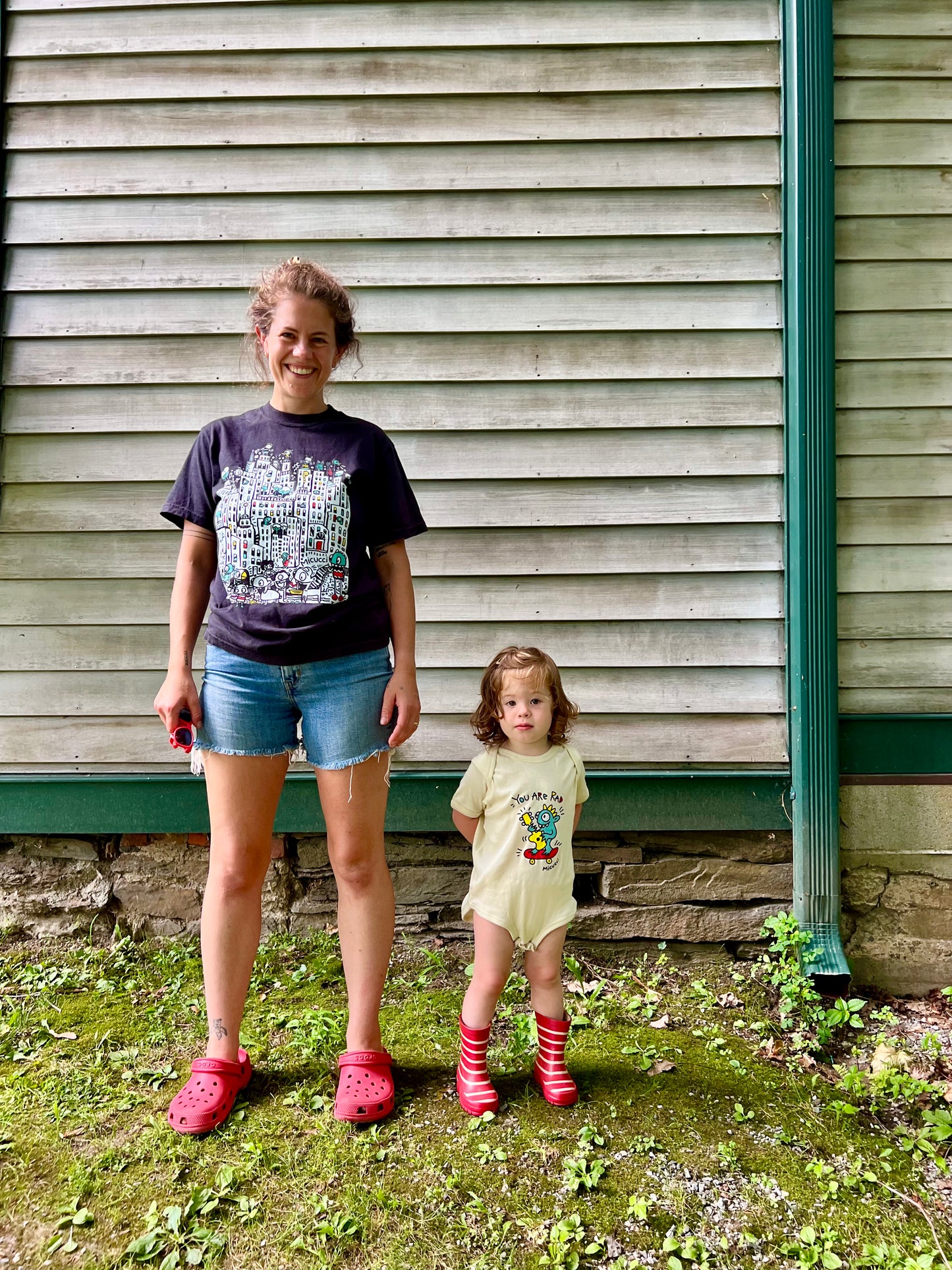 Two people standing in front of a wooden building