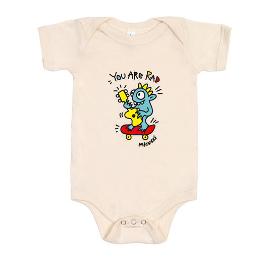 Beige baby onesie with cartoon character and text on a white background