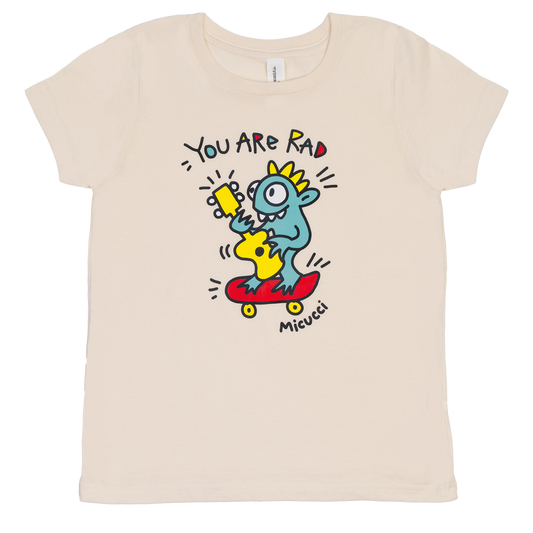 Beige t-shirt with a colorful graphic of a cartoon character and text on a white background